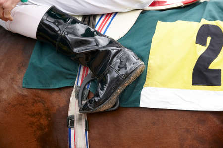 Jockey boot detail and race horse  の写真素材