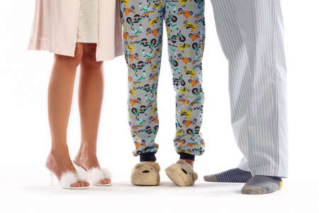 Family dressed in pyjama isolated on white  Horizontal
