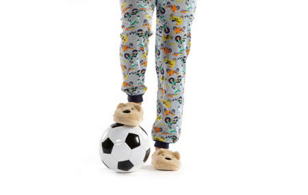Boy dressed in pyjama and football ball isolated on whiteの写真素材