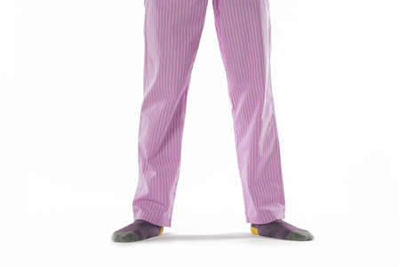 Young man dressed in pyjama and football ball isolated on whiteの写真素材