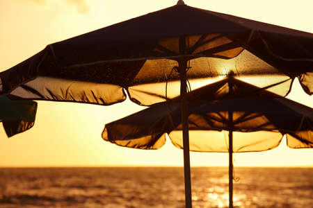 Sunshades at sunset in a mediterranean beach. Crete. 