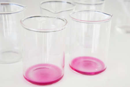 Test tubes with red liquid and white background. Horizontal format