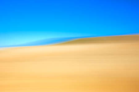 Yellow and blue landscape view from a train. Horizontal formatの写真素材