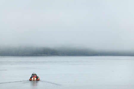 Rescue boat in the ocean with fog. Vancouver. British Columbia. Canadaの写真素材