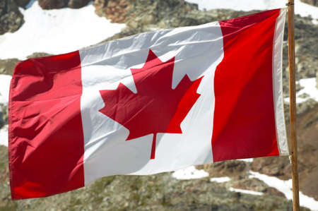 Canadian flag with mountain background. British Columbia. Canada. Horizontalの写真素材