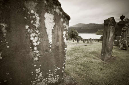 Scottish graveyard and Loch Ness in sepia tone. Horizontalの写真素材