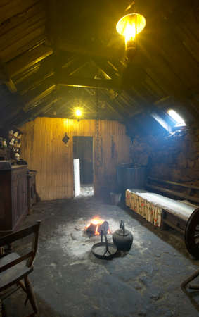 Traditional scottish home interior with peat fire. Lewis isle. UK. Verticalのeditorial素材