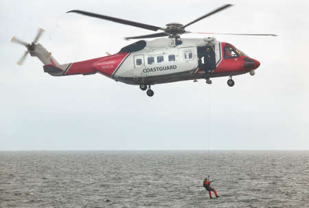 Coastguard rescue helicopter team in action. Scotland. UK. Horizontal