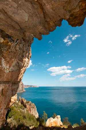 Mediterranean coastline landscape with cave in Alicante. Spain. Vertical