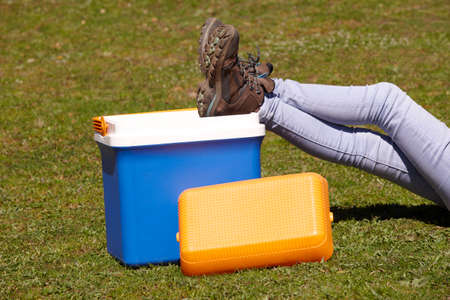 Picnic cooler in the grass and trekking boots in Spain. Horizontalの写真素材