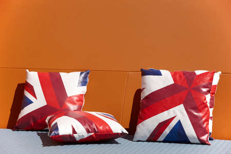 Chill out zone with british colors cushions and orange wall. Horizontalの写真素材
