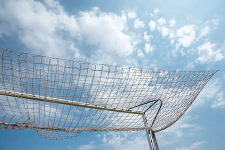 Packed football goal net and blue sky. Horizontalの写真素材