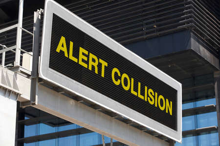 Alert collision signpost in the city with building facade . Horizontalの写真素材