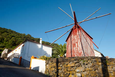Red rusty windmill in Azores. Sao Jorge island. Portugal. Horizontalの写真素材
