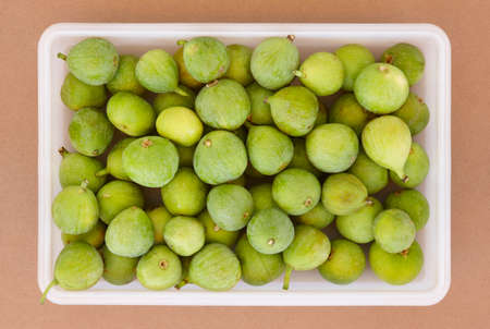 Fresh green figs on a plastic container viewed from above. Horizontalの写真素材