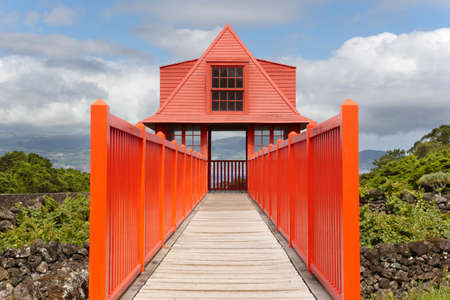 Red wooden viewpoint pathway in Pico island vineyard. Azores. Portugal. Horizontalの写真素材