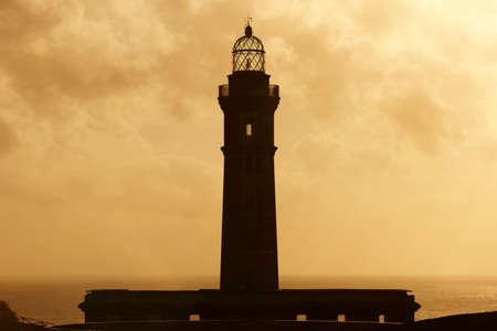 Lighthouse at sunset in Faial island. Ponta dos Capelinhos. Azores. Horizontalの写真素材