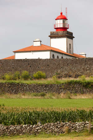 Lighthouse and cornfield in Lajes de Flores, Azores. Portugal. Verticalの写真素材