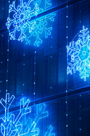 Christmas lights decoration on a building facade in blue tone. Verticalの写真素材