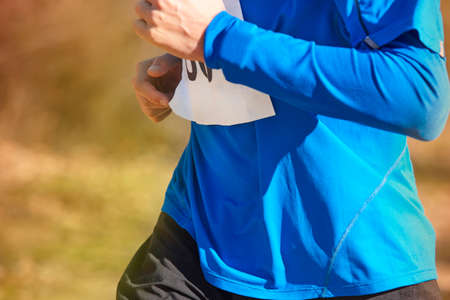 Young athletic runners on a race. Outdoor circuit. Horizontal