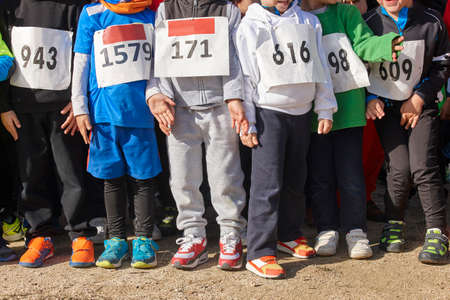 Athletic children ready to start a cross country race. Outdoors. Horizontalの写真素材