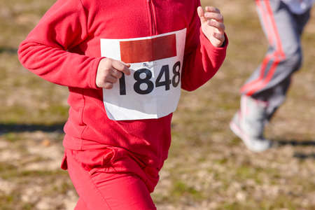 Young athletics runner on a race. Outdoor circuit. Horizontalの写真素材