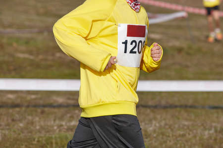 Young athletic runner on a cross country race. Outdoor circuit. Horizontalの写真素材