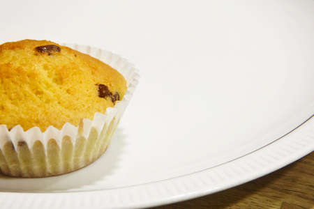 One cupcake over a white dish. Copy space. Horizontalの写真素材