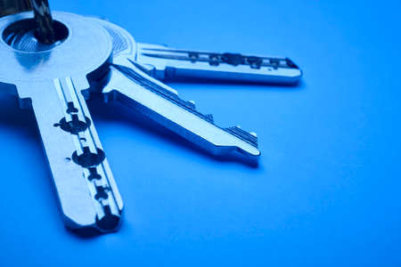 Keyring with keys in blue tone over an empty background. Horizontalの写真素材