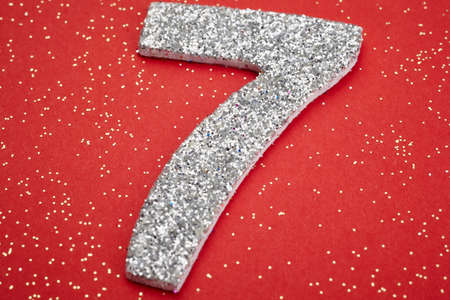 Number seven silver color over a red background. Anniversary. Horizontalの写真素材