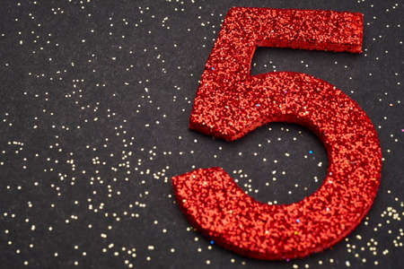 Number five red color over a black background. Anniversary. Horizontalの写真素材