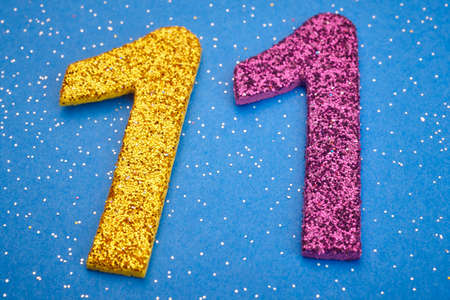 Number eleven yellow purple color over blue background. Anniversary. Horizontalの写真素材