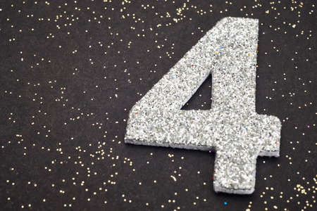 Number four silver color over a black background. Anniversary. Horizontal