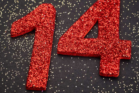 Number fourteen red color over a black background. Anniversary. Horizontalの写真素材