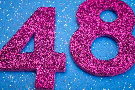 Number fortyeight purple color over a blue background. Anniversary. Horizontalの写真素材