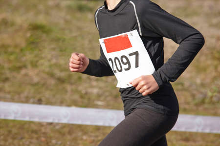 Young athletic runner on a cross country race. Outdoor circuit. Horizontalの写真素材