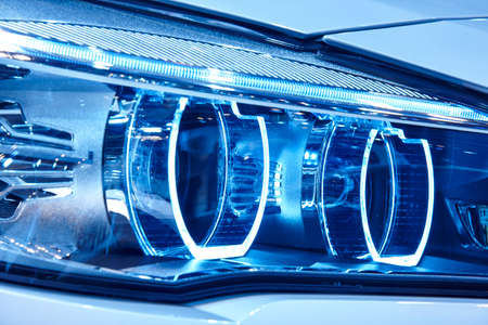 Car light detail in blue tone. Vehicle part. Vertical format