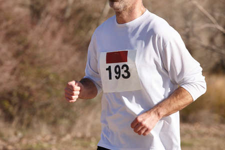 Male athletic runner on a cross country race. Outdoor circuit. Horizontalの写真素材