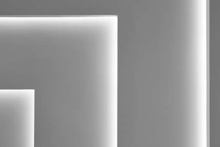 Grey wall with gradient light decoration in angle. Horizontalの写真素材