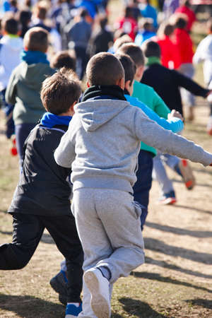 Children athletics runner on a cross country race. Outdoor circuit. Verticalの写真素材