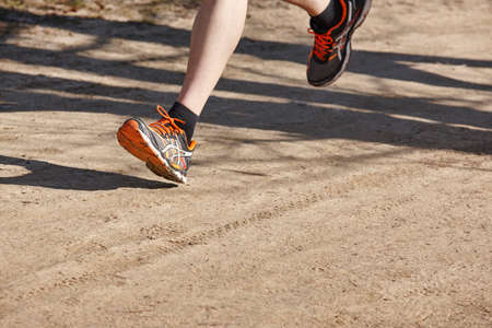 Senior athletic runner leg detail. Outdoor circuit. Horizontal
