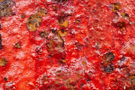 Red paint over a metallic textured and rusty background. Horizontalの写真素材