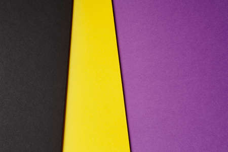 Colored carboards background in black yellow purple tone. Copy space. Horizontalの写真素材