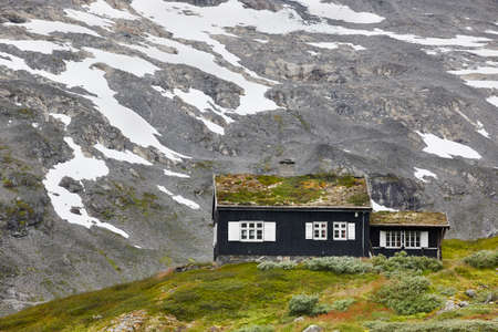 Traditional norwegian mountain landscape with black wooden house. Travel Norway. Horizontalのeditorial素材