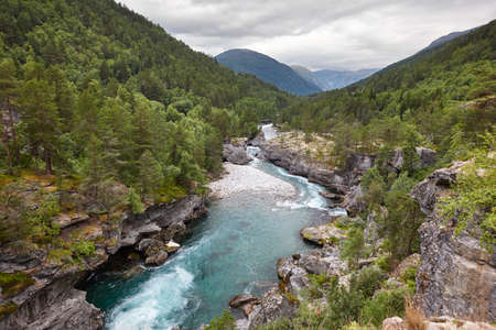Norwegian landscape with river and forest. Slettafossen waterfall. Norway tourismの写真素材