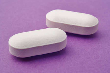 Pills over a purple background. Medicament treatment. Health care photo