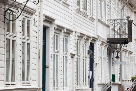 Traditional white wooden norwegian buildings facades in Bergen. Norway tourismのeditorial素材