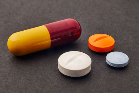 Pills over a black background. Medicament treatment. Health care photoの写真素材