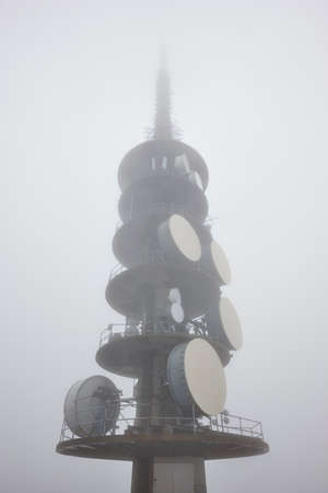 Outdoor telecommunication antenna detail covered with fog. Vertical