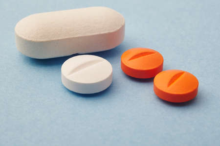 Pills over a blue background. Medicament treatment. Health care photo